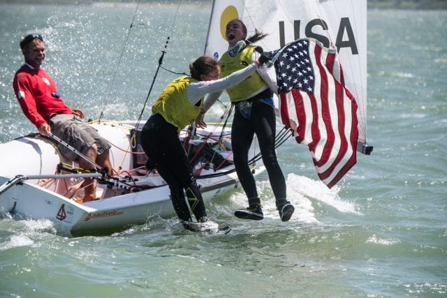 Carmen (center) and Emma Cowles celebrate their gold medal in the Girls' 420 Class (Jen Edney/World Sailing photo).
