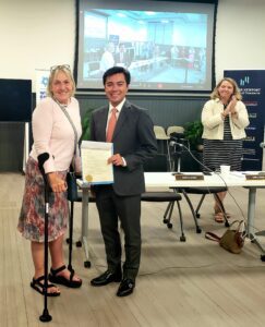 Betsy Alison recieving her proclamation for Betsy Alison Day from City of Newport Mayor Khamsyvoravong and Council